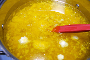 The liquid oils, and solid butters, are set on the stove over low heat