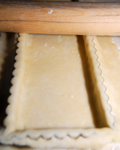 Once the pastry is seated in the pan, trim it with your rolling pin